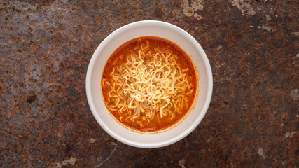 hot and sour noodle soup, Tom Yum shrimp flavor in white ceramic bowl on rusty texture background, Tom Yum Goong, Tom Yum Kung, Thai food