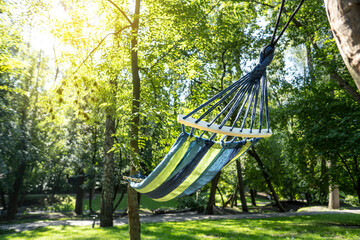 Colorful hammock for relaxing in a sunny park.