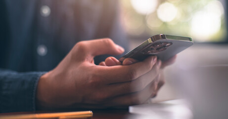 Businessman is working on Smartphone in coffee shop. stock business or work from home and concept. vintage tone