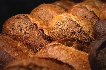 Fresh artisan bread. Loaves of delicious wholesome natural hot bread. Healthy food production and proper nutrition concept