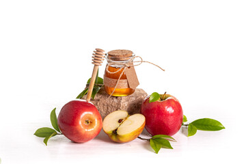 Red apples and honey on white background, traditional food of Jewish New Year - Rosh Hashanah.