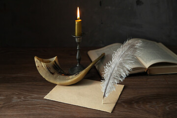 Shofar (horn), Torah book, burning candle, sheet of paper and feather pen. Jewish holiday of Yom...