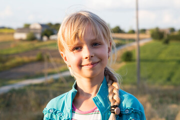 Portrait of a girl's face close-up in a field in nature.