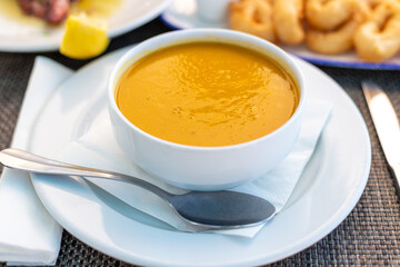 Pumpkin soup in a white bowl, Praia do Garrão, Algarve
