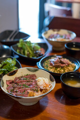 Steak Don, a Japanese dish consisting of a bowl of rice topped with rare beef with egg