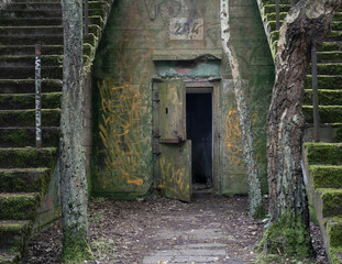 Open steel door of abandoned concrete military bunker in Hel, Poland. World war two and cold war...