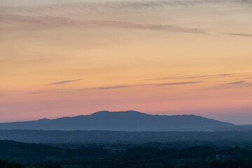 Mountain in haze and beautiful vivid colors in sky at dusk