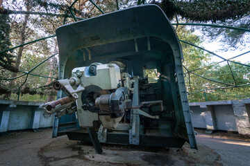 Closeup shot of the back of old masked cannon from nineteen-forties, positioned on top of concrete...