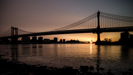Fototapeta na wymiar Sunrise reflection and bridge in New York Harbor