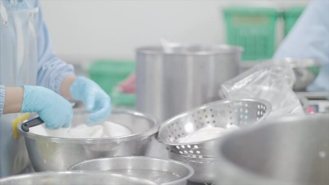 Factory workers process coconut meat for packaging. 