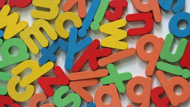 Multi colored English alphabet made from wood isolated on white background.