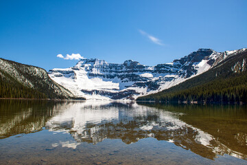Fototapeta na wymiar Mountain Lake with Snow Capped Mountains