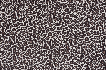 Fabric background with a print of the skin of a wild animal - leopard, cheetah. In clothes with a leopard print, a person feels brave and strong