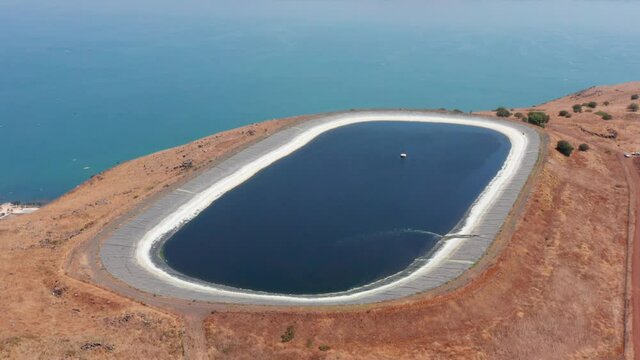 Water reservoir on top of Arbel cliff overlooking The Sea of Galilee, Aerial view.