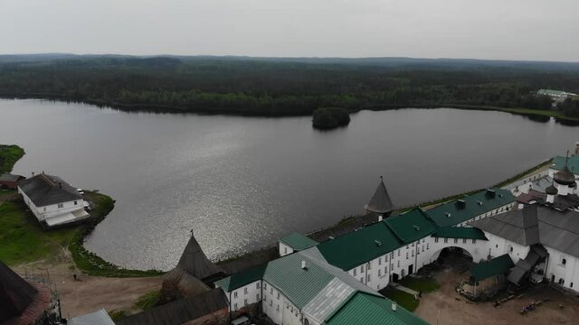A slow flight near the walls and towers of the Solovetsky Kremlin on a cloudy day with soft lighting. This is part of the fortress of the Solovetsky monastery - an old (1420) ROC monastery.