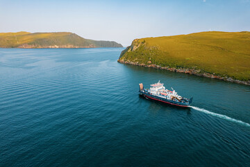 A ferry from the east coast to Olkhon Island Khuzhir at sunrise. Lake Baikal. From the side of the...