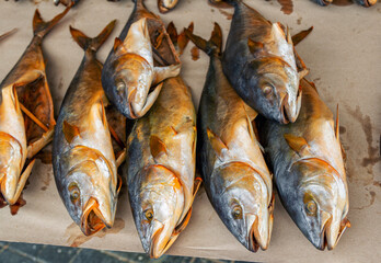 Smoked salted fish on a paper at outdoors seafood market
