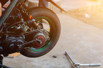Blurred image,motorcycles repair after a tire leak during a long journey. Modifying some parts of a car when it is used for a certain period of time by an expert technician. motorcycles repair