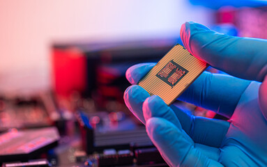 manipulating and installing processor on the motherboard in details with blur and selective focus