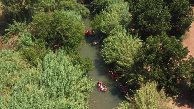 Rubber boats at the Jordan River, heading downstream - Aerial view.
