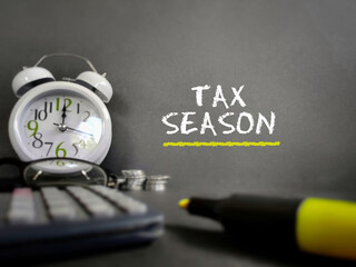 Tax-filling concept - Tax season text in vintage background. Stock photo.