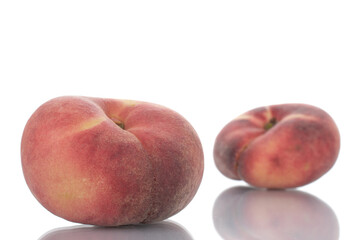 Fototapeta na wymiar Two juicy organic peaches, close-up, isolated on white.