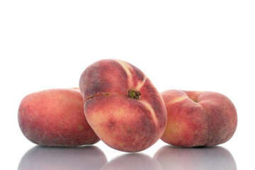 Three juicy organic peaches, close-up, isolated on white.