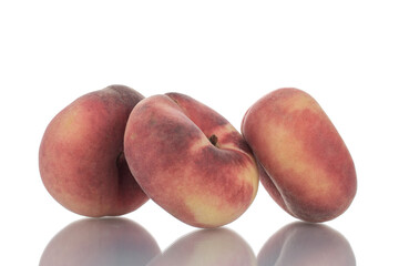 Three juicy organic peaches, close-up, isolated on white.