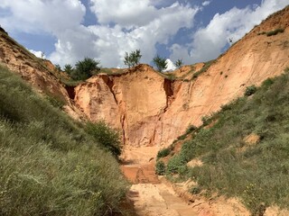Sand quarry and clouds. Green grass