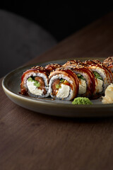 Baked sushi roll Canada with salmon, cream cheese.