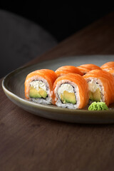 Philadelphia roll sushi with salmon, prawn, avocado, cream cheese. Sushi menu.