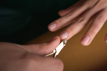 Close-up of hand and nail pliers. doing hand nails. care with your nails. manicure.
