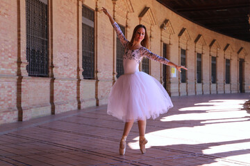 Obraz premium classical ballet dancer dancing and doing different ballet postures. The ballerina is wearing a white tutu. Ballet concept