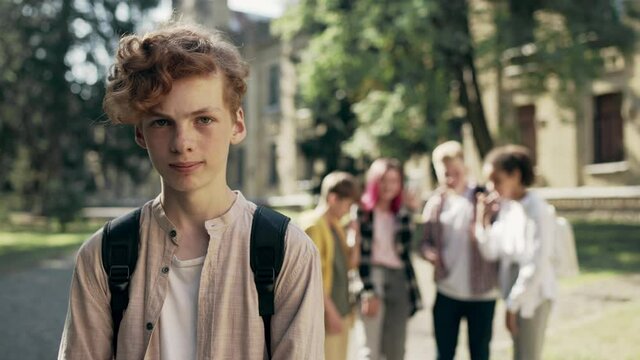 Cruel kids bullying unpopular classmate, teen boy suffering socializing problem