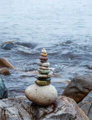Fototapeta na wymiar Stack of stones near the sea with water at background.