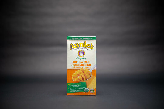 Fort Myers, FL, USA &ndash; 8-29-2021: A box of Annie&rsquo;s Homegrown certified organic shells and real aged cheddar macaroni and Cheese. Branded as usda organic with no gmo isolated on black background. 