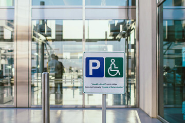 White Parking Sign on the Street Showing Direction for People and Cars Outdoor