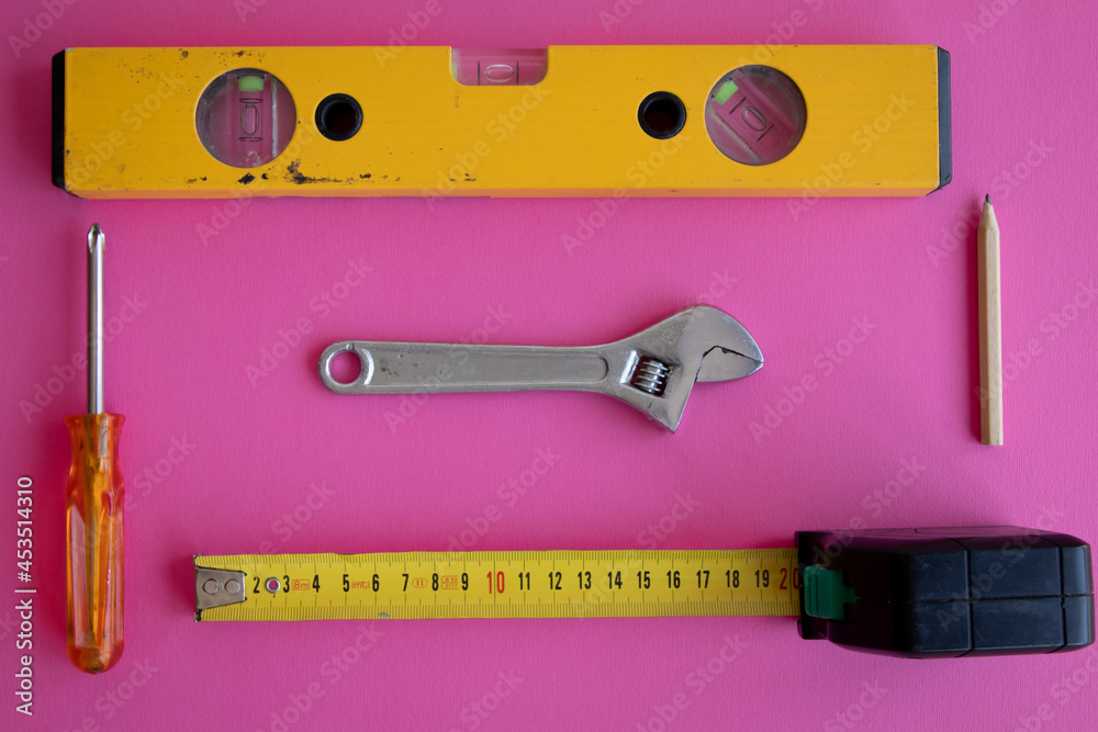 Poster Top view of a bunch of tools on a pink background