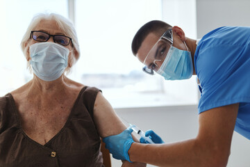 Fototapeta na wymiar elderly woman wearing medical mask vaccination hospital immunity protection