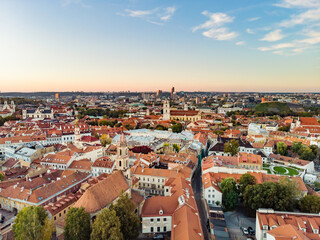 Beautiful Vilnius city panorama in autumn with orange and yellow foliage. Aerial evening view.