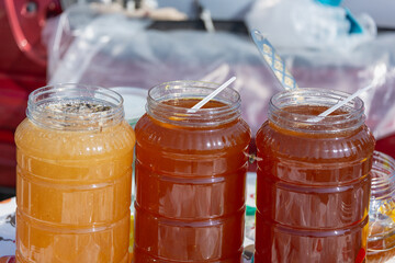 Bee honey in plastic jars.