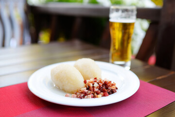 Lithuanian cepelinai, dumplings made of grated and riced potatoes and stuffed with ground meat, dry...