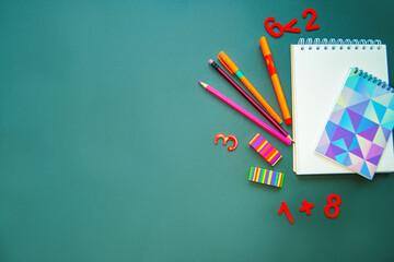 School supplies flat lay. Stationery on green color background, top view. Education, Back to...