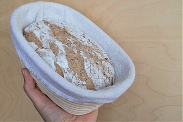 hand holding a homemade dough basket