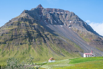 Fototapeta na wymiar Church of Bolungarvik and mountain Ernir in the westfjords of Iceland