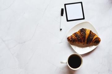 Businessman working morning with notebook, pen, cup of hot coffee and croissant on white background. Top view, copy space, mockup. Flat lay. Healthy food concept.
