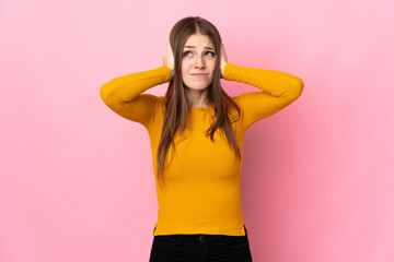 Young caucasian woman isolated on pink background frustrated and covering ears