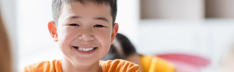 happy asian schoolboy smiling at school, banner