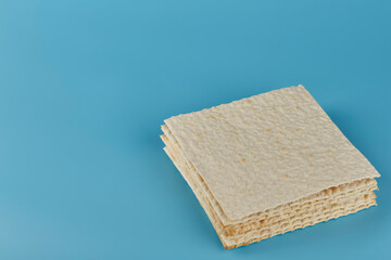 Jewish kosher matzo for the holiday on a blue background
