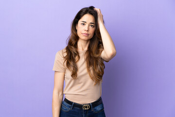 Fototapeta premium Woman over isolated purple background with an expression of frustration and not understanding